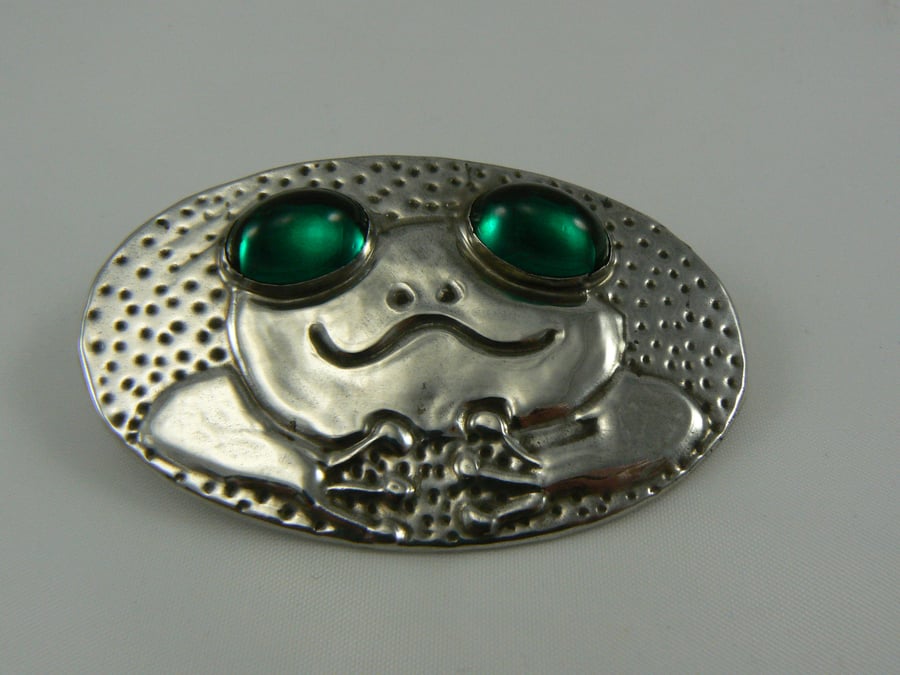 Pewter frog Brooch with green cabochon eyes