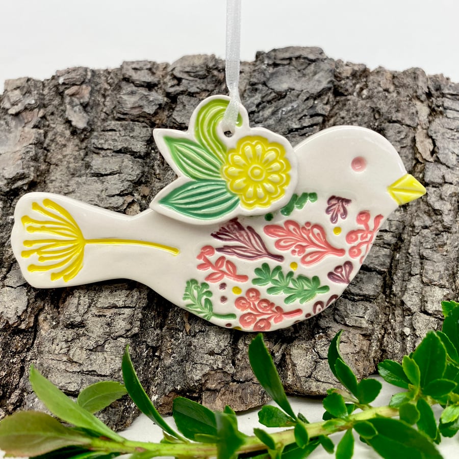 Ceramic bird hanging decoration with yellow flower detail