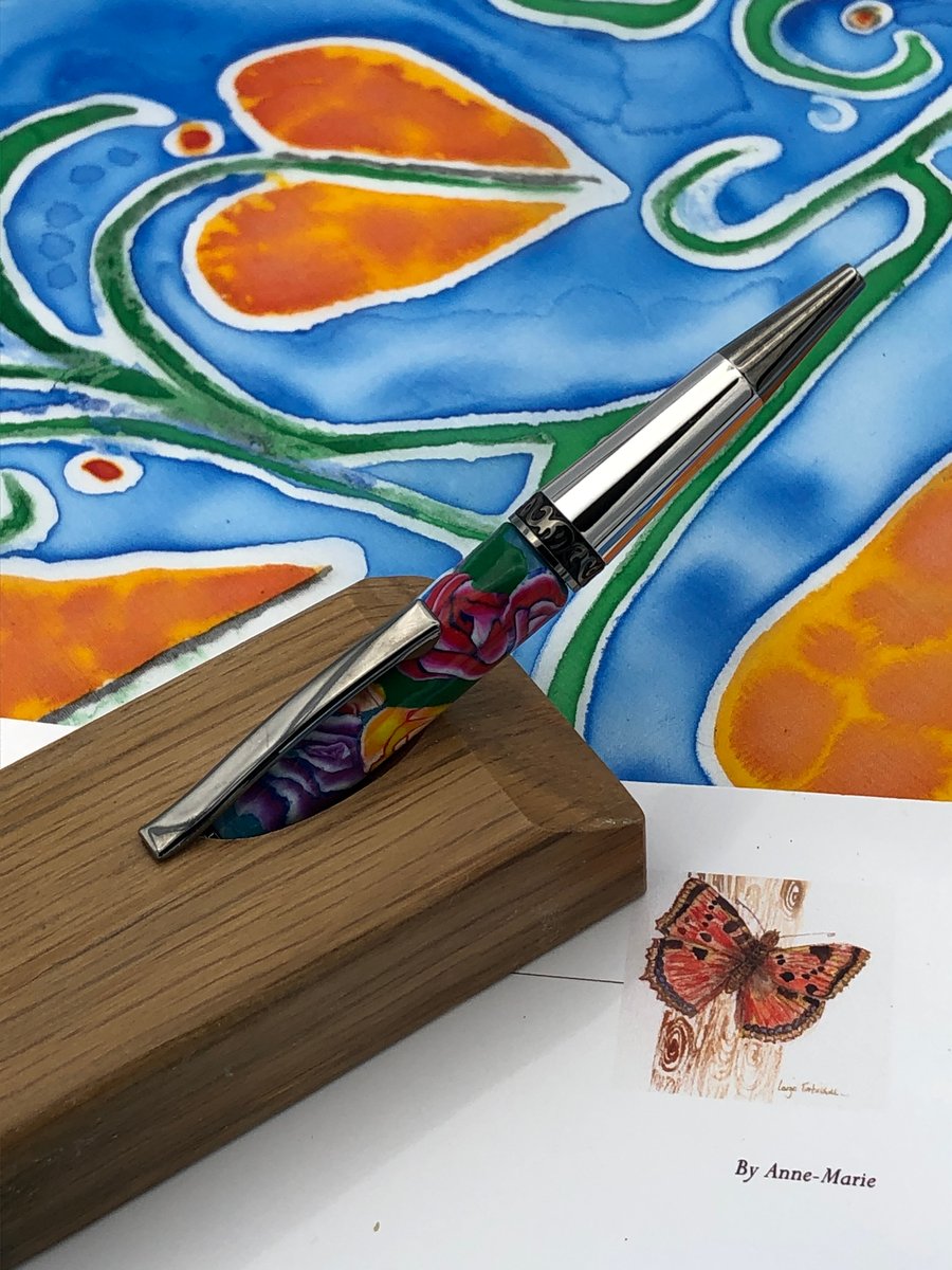 Pen on oak stand, with decorated polymer clay barrel