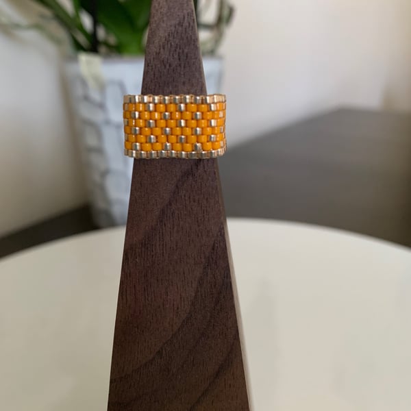 Luminous orange and gold coloured beaded ring