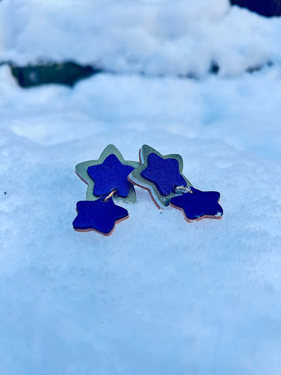 Star dangle earrings made from metallic navy blue and green leathers 