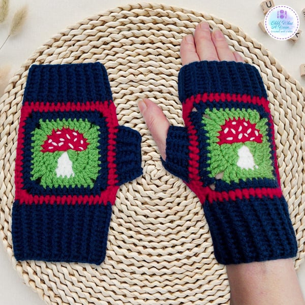 Crochet gloves in a navy blue, red and green toadstool design. Toadstool gloves.