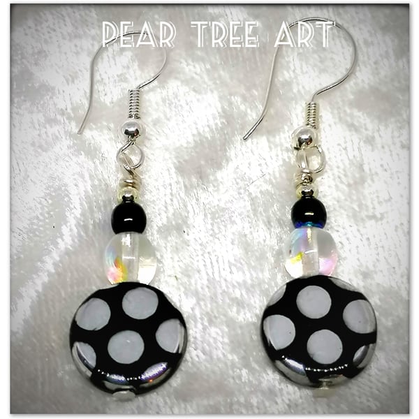  Glass bead earrings with metallic spot pattern on silver plated hooks.