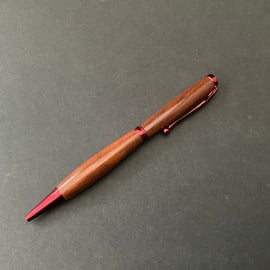 Slimline twist ballpoint pen made with milk pear hardwood and red fittings