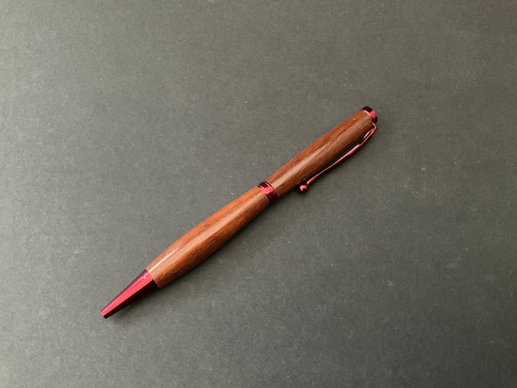 Slimline twist ballpoint pen made with milk pear hardwood and red fittings