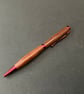 Slimline twist ballpoint pen made with milk pear hardwood and red fittings - Image 1