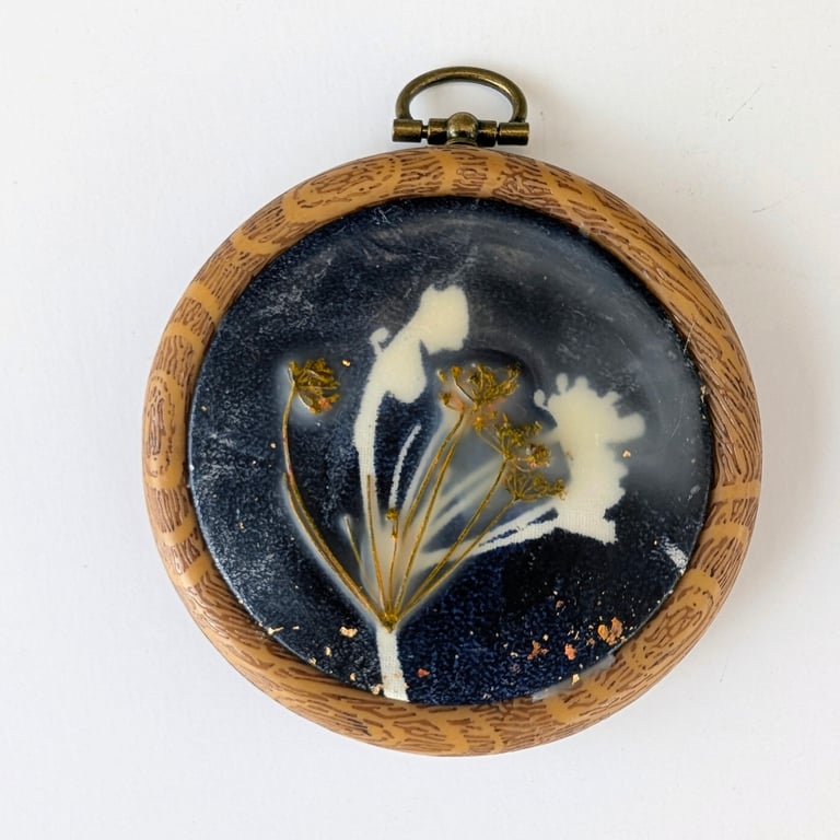 "Winter seedhead" is a mixed media piece of art in a hoop