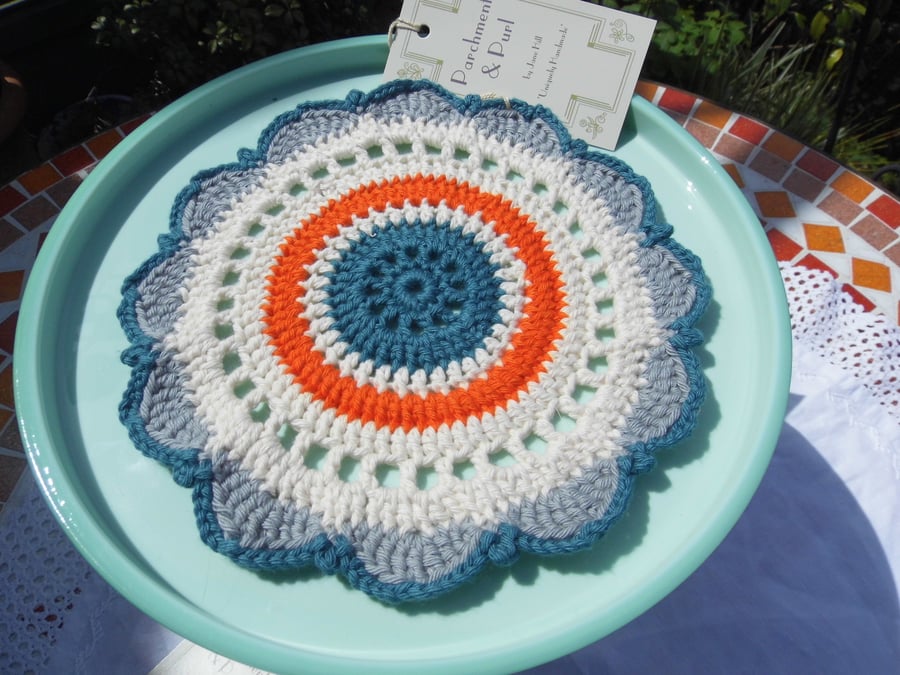 Crochet doily table mat centrepiece decoration in vintage shades.