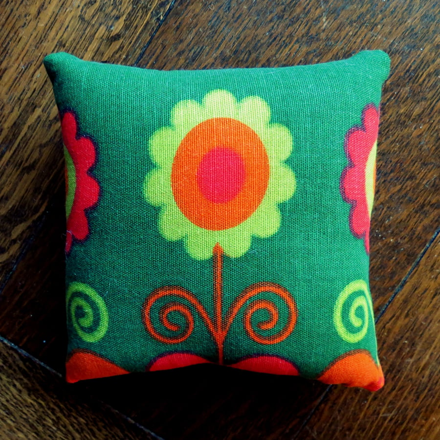 A pin cushion made from an iconic flower power fabric from the 1960s.