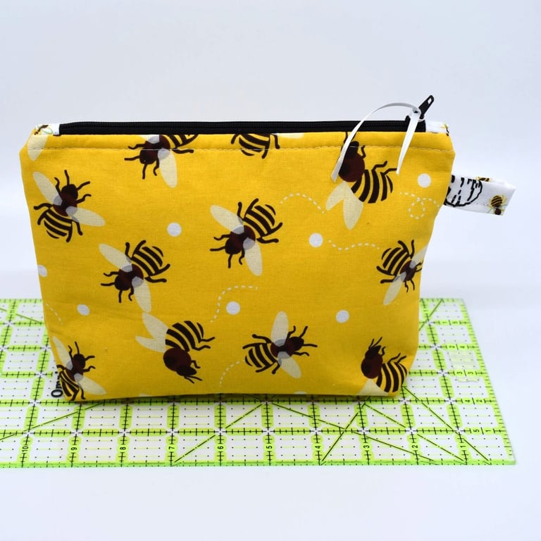 A bright yellow buzzy bee pouch with bees inside too!