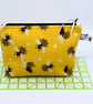 A bright yellow buzzy bee pouch with bees inside too!