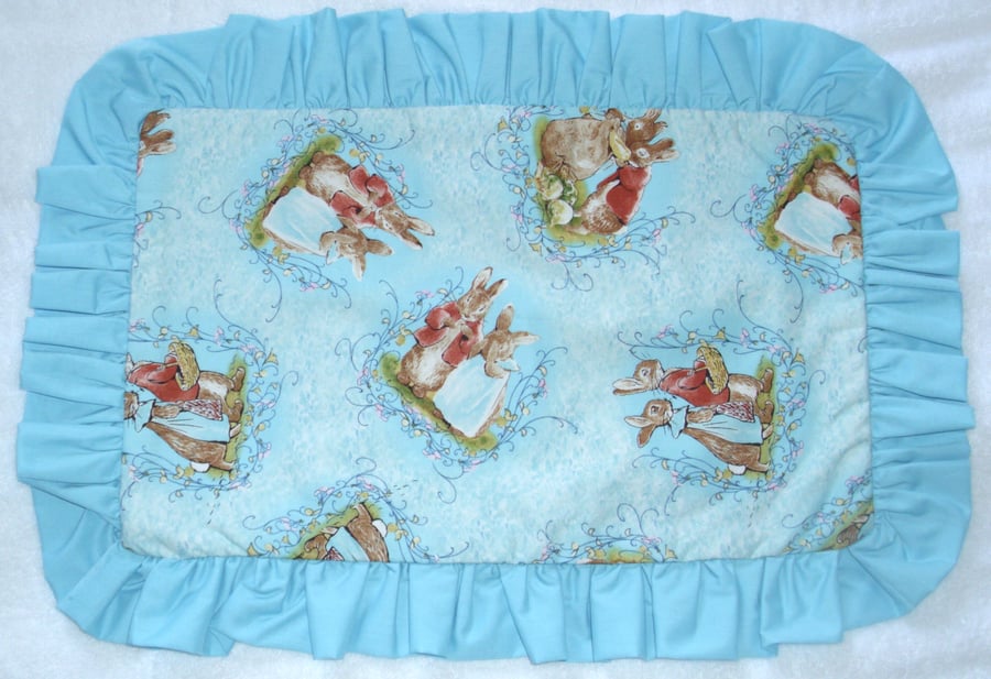 Mr and Mrs Bunny tossed on a turquoise pillow