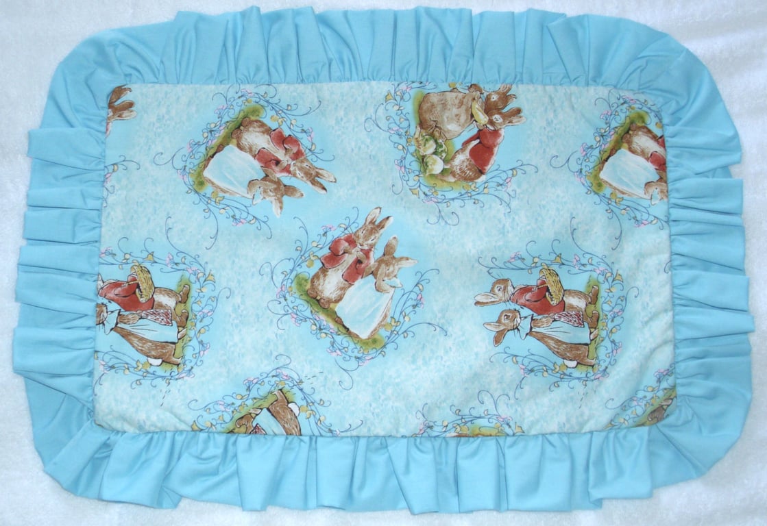 Mr and Mrs Bunny tossed on a turquoise pillow