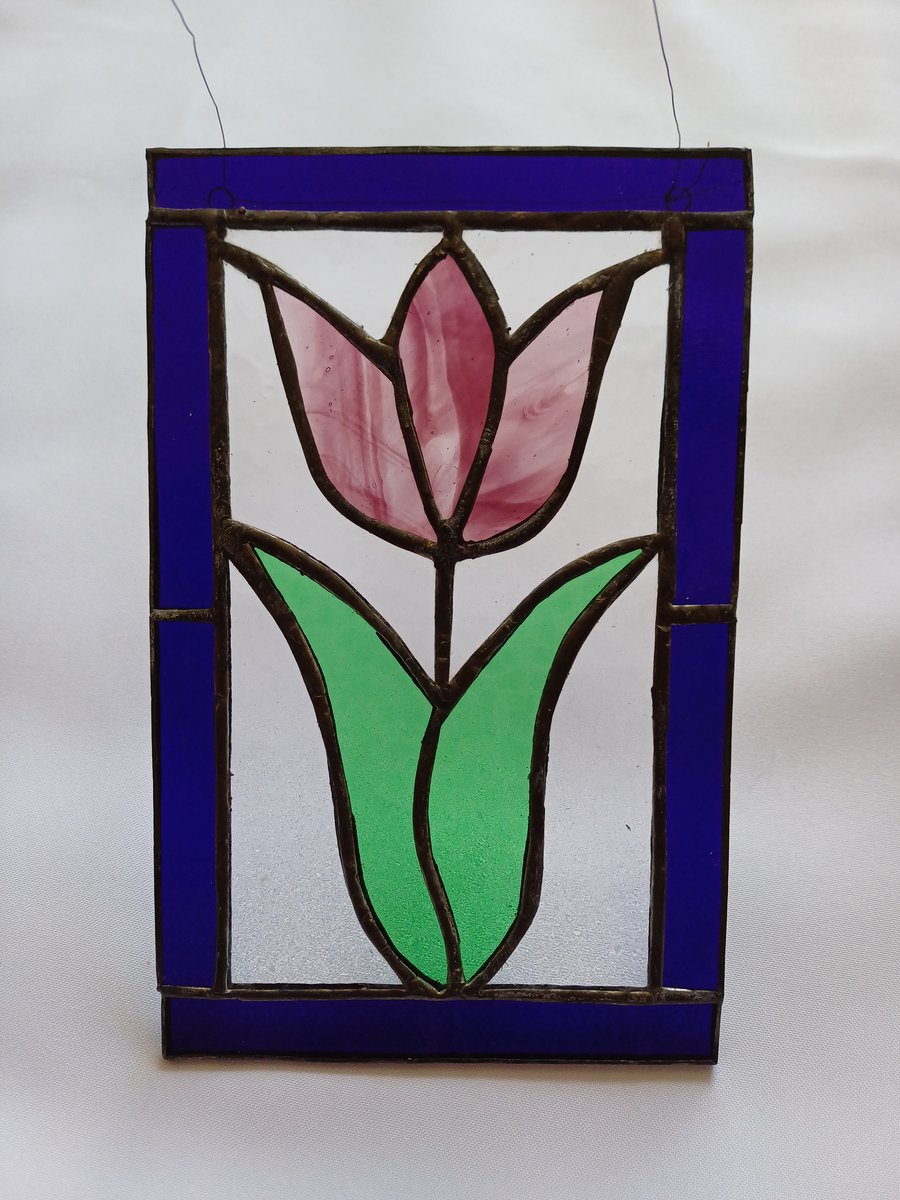 Stained glass tulip framed with dark blue glass