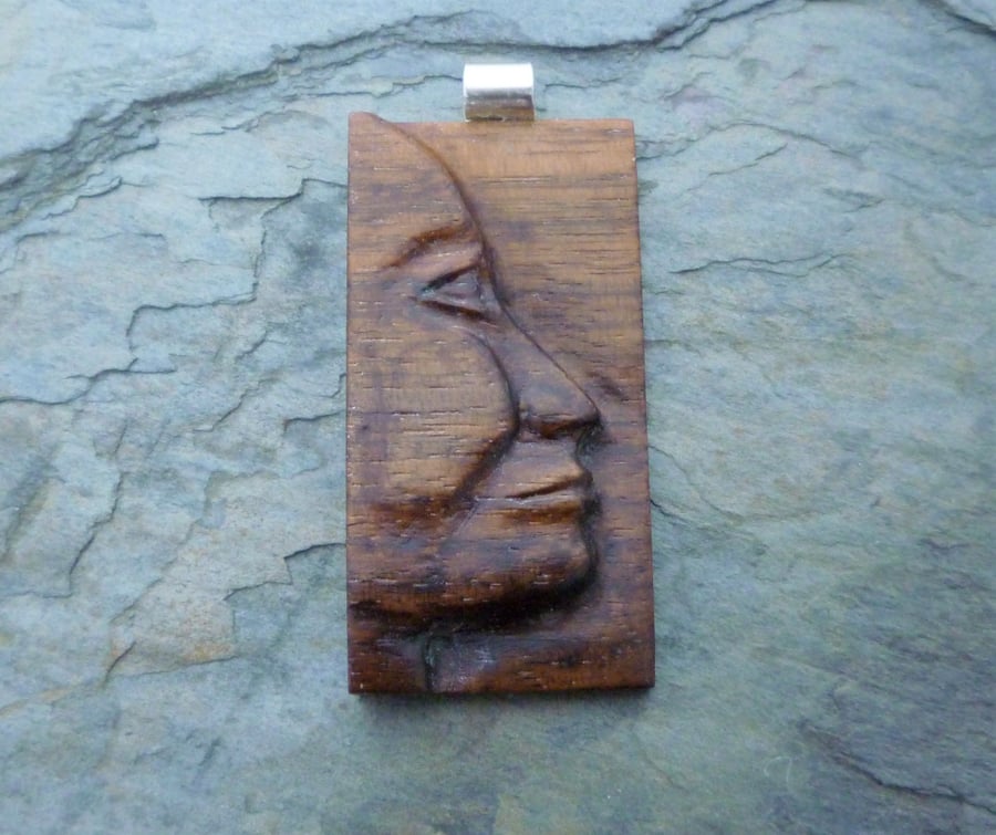 Carved wooden face pendant, walnut and silver