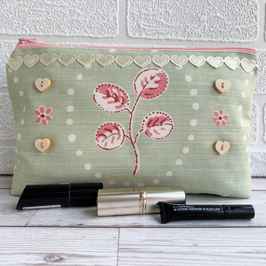 Large make up bag in pale green and pink print fabric with ribbon and buttons