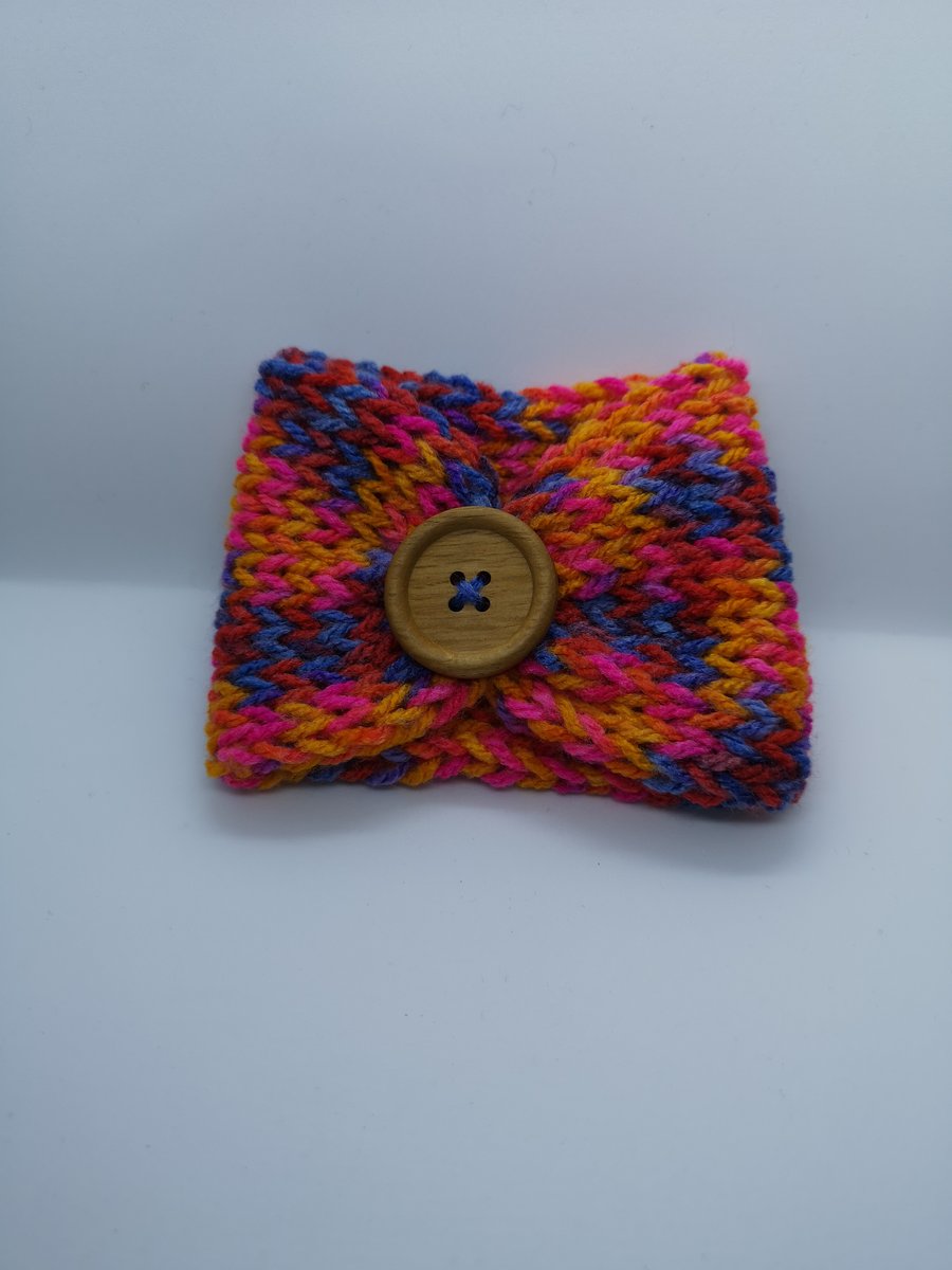 Handknitted rainbow cup cosie