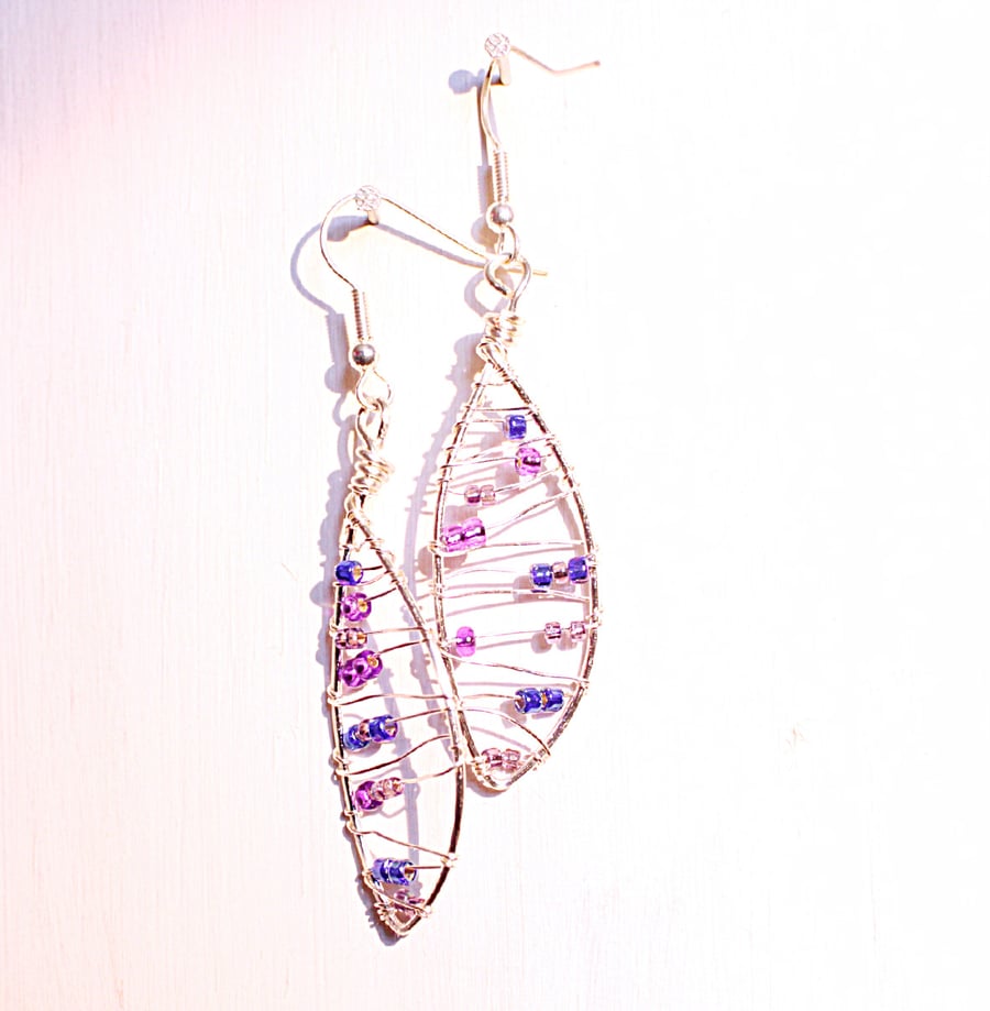 Silver leaf shaped wire wrapped dangle earrings with blue and purple seed beads