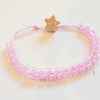 Pink beaded bracelet with wooden star button.