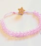 Pink beaded bracelet with wooden star button. - Image 1