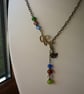 MULTI COLOURED & ANTIQUE BRONZE LEAF AND BIRD LARIAT DESIGN NECKLACE.  1011