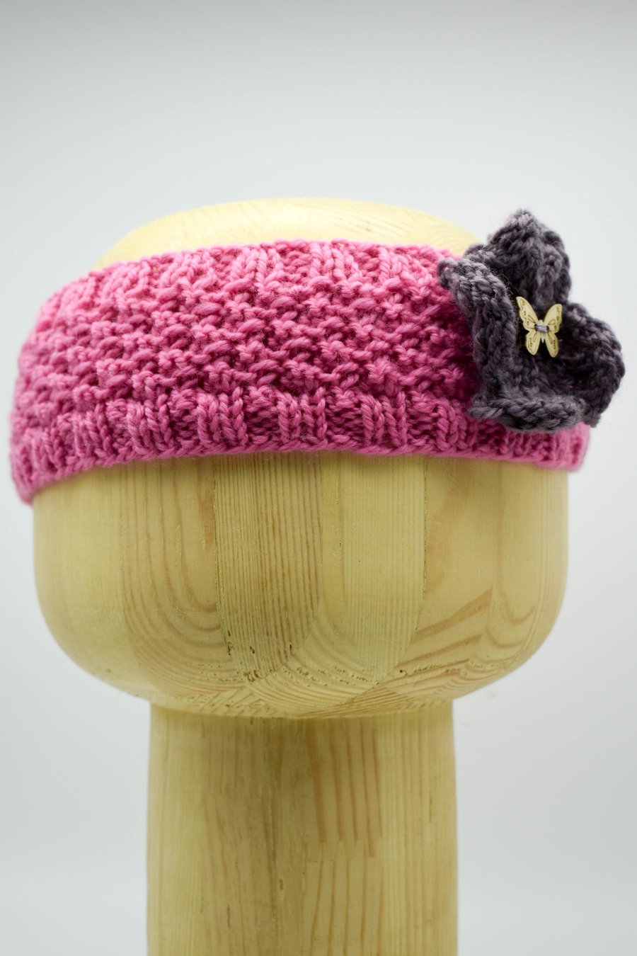Hand Knitted "Daisy" Head band in pink with a mauve flower