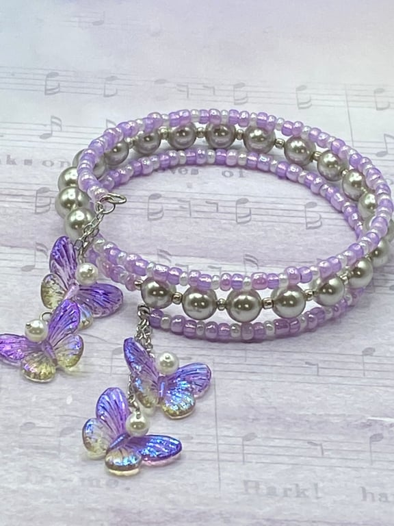 Lilac and shell pearl beaded memory wire bangle with butterfly charms