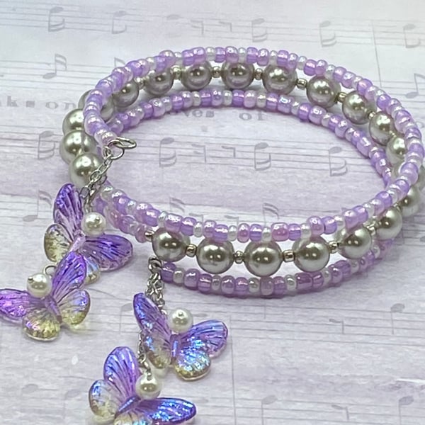Lilac and shell pearl beaded memory wire bangle with butterfly charms