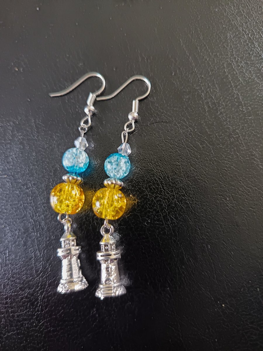 Silver lighthouse charm dangle earrings with yellow and blue beads