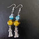 Silver lighthouse charm dangle earrings with yellow and blue beads