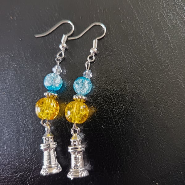 Silver lighthouse charm dangle earrings with yellow and blue beads