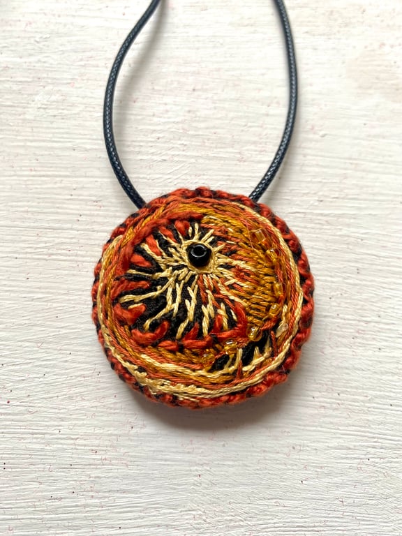 Autumnal hand embroidered circular pendant, abstract design 