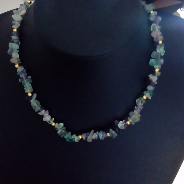 A raw crystal chip bead necklace with gold or silver plated lobster clasp.
