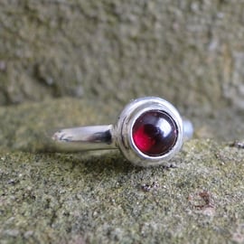 Silver ring with a Garnet in an organic silver mount UK size O