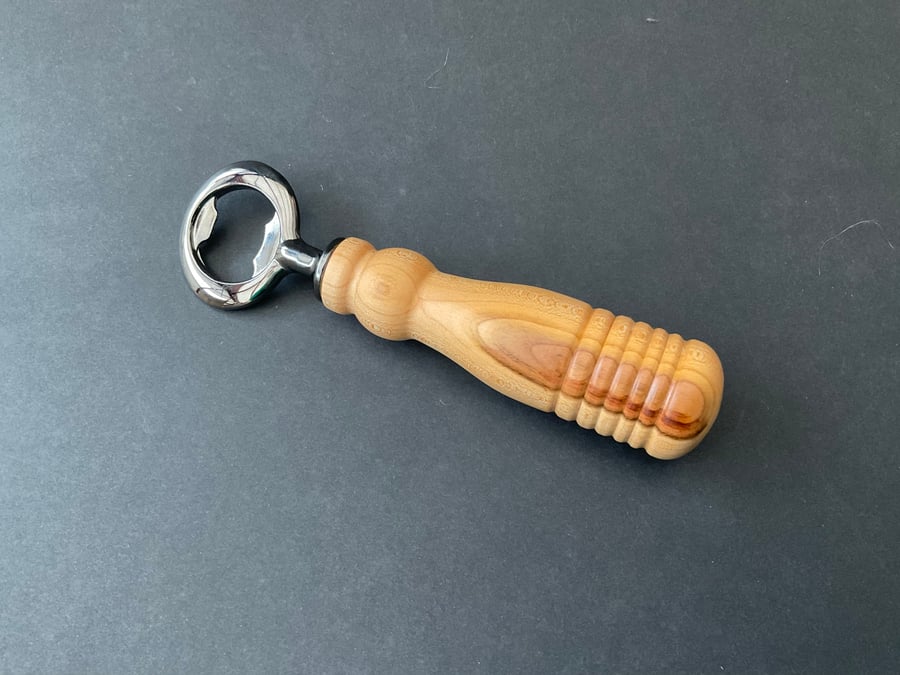 Bottle opener made with plum hardwood