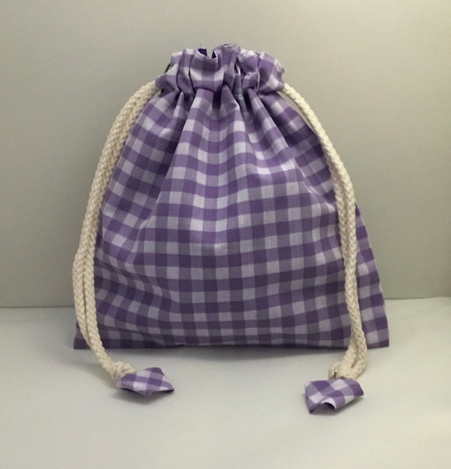 Purple gingham toiletries bag and wash mitts.