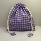 Purple gingham toiletries bag and wash mitts.
