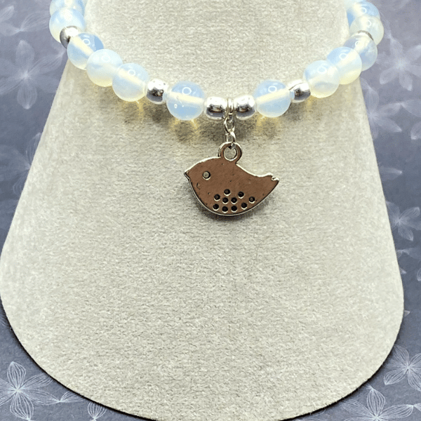 Stretchy bracelet with opalite stones and silver plated bird charm