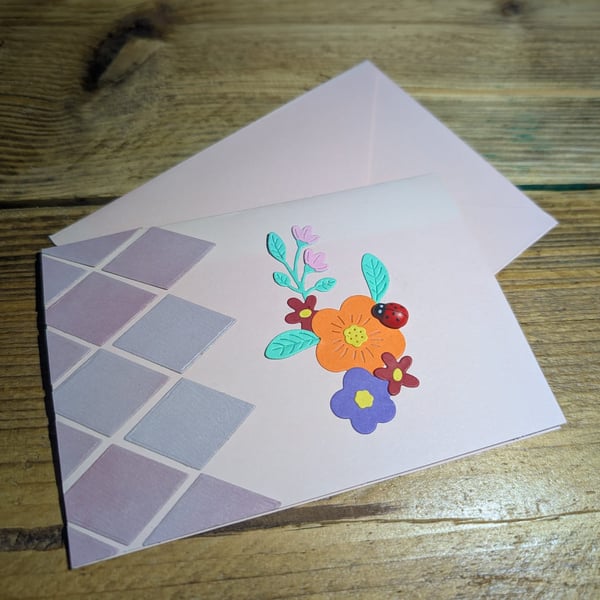 Handmade floral design card with ladybird embellishment