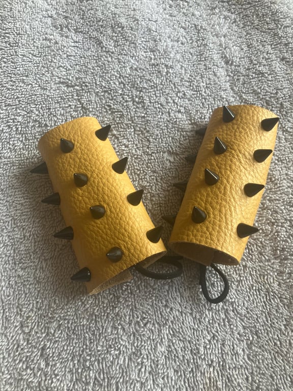 Yellow Leather with Black Spikes: Wheelchair Handle Deterrents (WHDs)