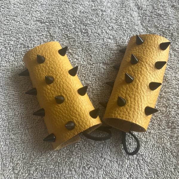 Yellow Leather with Black Spikes: Wheelchair Handle Deterrents (WHDs)