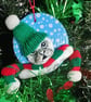 Christmas tree decoration of a Seal, airdry clay with a fabric hat and scarf.   - Image 1