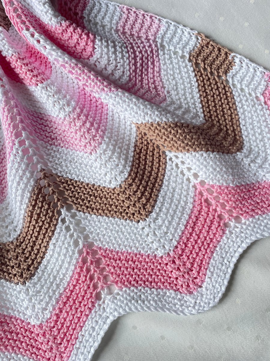 Pink white and chocolate brown, hand knitted baby blanket.