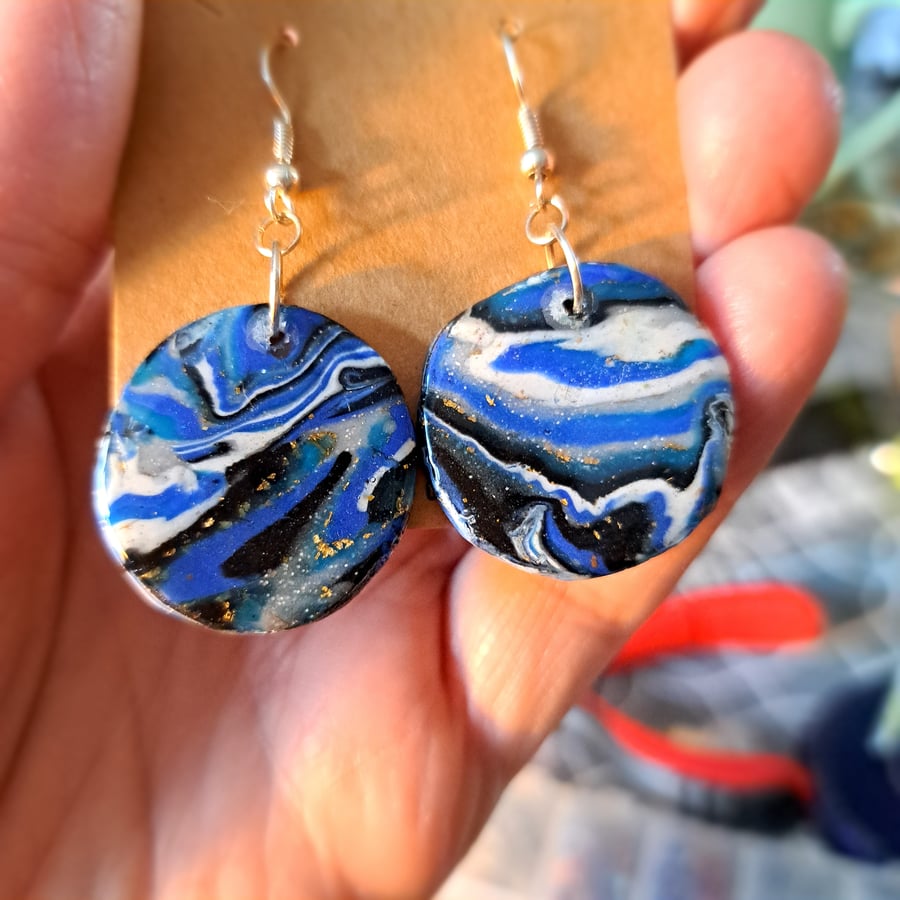 Circular pair of blue, white,  black and gold glittery polymer clay earrings