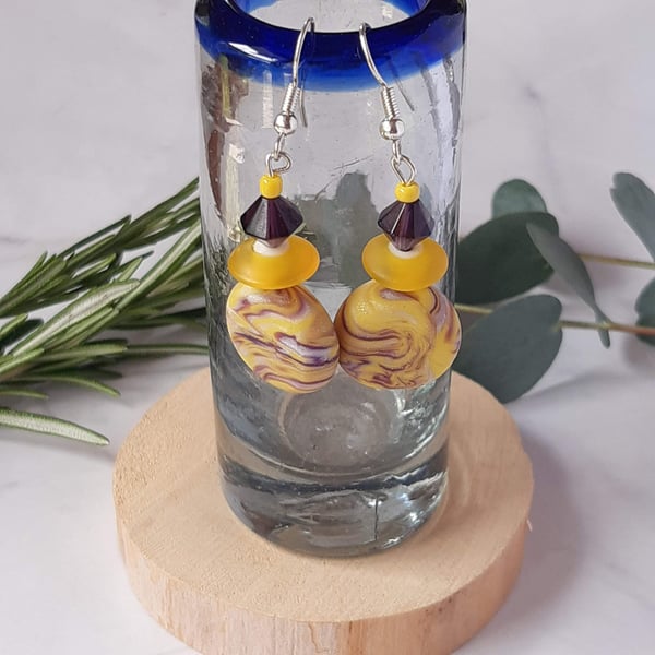 Handmade dangly  polymer clay disc earrings in yellow and purple