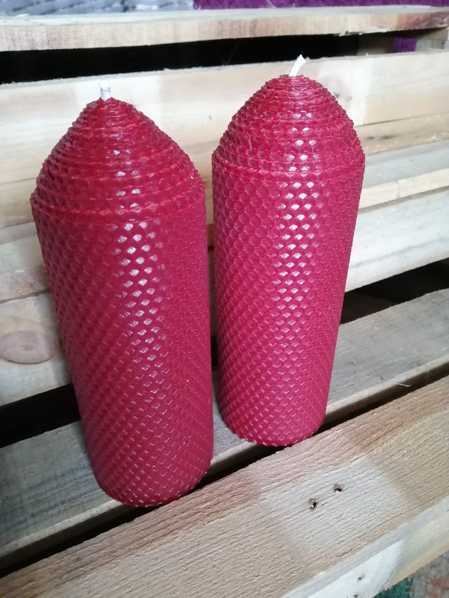 A pair of Dark Red rolled beeswax candles 70mm diameter x 195mm high