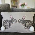 Handmade taupe-grey linen cushion with sewn printed rabbit & fluffy pompom tails