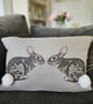 Handmade taupe-grey linen cushion with sewn printed rabbit & fluffy pompom tails - Image 1