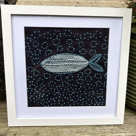 Hand embroidered fish in the sea.