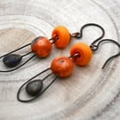 copper, orange lampwork glass and ceramic earrings